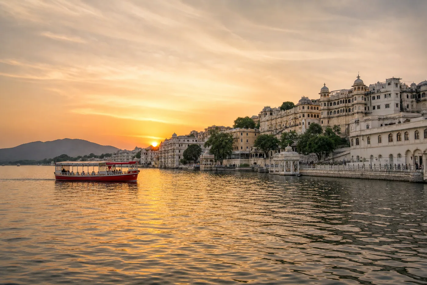 Lake Pichola and palace architecture at sunset in Udaipur